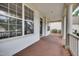 Spacious porch view featuring a wood floor, white columns and exterior trim at 120 Hatchet Creek Ct Ct, Morrisville, NC 27560