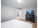 Bedroom with hard surface flooring, television, and an open doorway to another room at 1402 Robinhood Rd, Durham, NC 27701