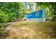 Blue exterior of home with unfinished backyard surrounded by trees at 1402 Robinhood Rd, Durham, NC 27701