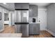 The kitchen boasts modern gray cabinetry, stainless steel fridge, and white subway tile backsplash at 1402 Robinhood Rd, Durham, NC 27701