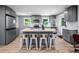 Modern kitchen featuring an island with seating for four and stainless appliances at 1402 Robinhood Rd, Durham, NC 27701