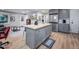 Open-concept living area featuring island with seating, stainless appliances, and comfortable living space at 1402 Robinhood Rd, Durham, NC 27701