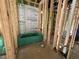Framed bathroom under construction with a green tub installed and plumbing visible at 1521 1/2 Sunrise Ave, Raleigh, NC 27608