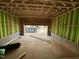 Under-construction garage showcasing framing, concrete flooring, and an opening leading outside at 1521 1/2 Sunrise Ave, Raleigh, NC 27608