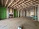Open-concept living room in construction phase, featuring exposed framing and high ceilings at 1521 1/2 Sunrise Ave, Raleigh, NC 27608
