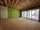 Framed living room under construction featuring large windows and wood subflooring at 1521 1/2 Sunrise Ave, Raleigh, NC 27608
