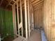 Staircase under construction, featuring exposed wood framing and green sheathing at 1521 1/2 Sunrise Ave, Raleigh, NC 27608