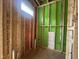 Unfinished bathroom with exposed framing, plumbing lines, and a window opening, showing the beginning stages at 1523 1/2 Sunrise Ave, Raleigh, NC 27608