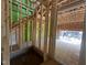Unfinished entryway showcasing the wooden framing and staircase structure of the home's interior at 1523 1/2 Sunrise Ave, Raleigh, NC 27608
