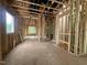 A view of the unfinished interior displaying exposed framing, window openings, and potential room layouts at 1523 1/2 Sunrise Ave, Raleigh, NC 27608
