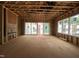 Unfinished living room with exposed framework, sliding glass doors, and several windows providing lots of light at 1523 1/2 Sunrise Ave, Raleigh, NC 27608