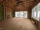 Unfinished living room with exposed framework, sliding glass doors, and several windows providing lots of light at 1523 1/2 Sunrise Ave, Raleigh, NC 27608