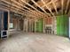 Open-concept living room with exposed framing offering a view of the staircase and other rooms in this unfinished home at 1523 1/2 Sunrise Ave, Raleigh, NC 27608