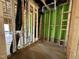 Unfinished bathroom featuring plumbing lines, stud framing, and exterior sheathing at 1523 Sunrise Ave, Raleigh, NC 27608