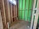 Unfinished bathroom displaying the stud framing, plywood subflooring, and plumbing system components at 1523 Sunrise Ave, Raleigh, NC 27608