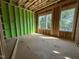 Unfinished bedroom showcases two windows offering views of the neighborhood and the surrounding trees at 1523 Sunrise Ave, Raleigh, NC 27608