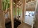 Unfinished entryway with stud framing, stairs, and exterior sheathing at 1523 Sunrise Ave, Raleigh, NC 27608