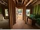Unfinished hallway with exposed stud framing, views to the exterior, and temporary construction materials present at 1523 Sunrise Ave, Raleigh, NC 27608