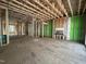 Unfinished living room featuring stud framing, exterior sheathing, and a fireplace at 1523 Sunrise Ave, Raleigh, NC 27608