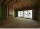 Unfinished living room featuring stud framing, exterior sheathing, and sliding glass doors at 1523 Sunrise Ave, Raleigh, NC 27608