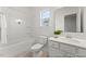 Bright bathroom with a shower-tub combo, toilet, and vanity with modern fixtures at 161 Nashua Dr # 2594P, Louisburg, NC 27549