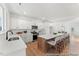 Bright kitchen features an island with seating, a sink, and white cabinetry at 161 Nashua Dr # 2594P, Louisburg, NC 27549