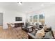 Living room boasts wood floors, comfortable seating, and a wall-mounted TV at 161 Nashua Dr # 2594P, Louisburg, NC 27549