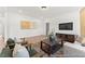 Bright living room features wood floors, comfortable seating, and a wall-mounted TV at 161 Nashua Dr # 2594P, Louisburg, NC 27549