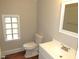 The bathroom features a vanity sink, toilet and window at 1610 W B St, Butner, NC 27509