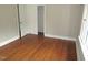 Clean, neutral bedroom with hardwood floors, closet and large door at 1610 W B St, Butner, NC 27509