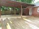 Outdoor wooden deck area with shelter and fans at 1610 W B St, Butner, NC 27509