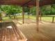 Back deck featuring wooden flooring and shelter at 1610 W B St, Butner, NC 27509
