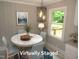Inviting dining area with a marble-topped table and modern light fixture at 1610 W B St, Butner, NC 27509