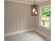 Dining area featuring wainscotting detail, decorative light fixture, and window at 1610 W B St, Butner, NC 27509