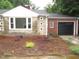 Charming home with a stone and brick exterior, featuring a well-manicured front yard and attached garage at 1610 W B St, Butner, NC 27509