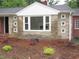 This home features a stone facade with unique window details and manicured landscaping at 1610 W B St, Butner, NC 27509