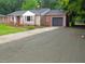 Charming single-story brick home with a well-maintained lawn and a paved driveway at 1610 W B St, Butner, NC 27509