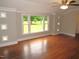 Living room featuring hardwood floors, large windows with decorative molding at 1610 W B St, Butner, NC 27509