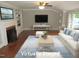 Bright living room boasts a cozy fireplace, built-in shelves, and large windows at 1610 W B St, Butner, NC 27509
