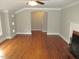 Living room with hardwood floors, fireplace and view of the entryway at 1610 W B St, Butner, NC 27509