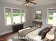 Staged bedroom features a ceiling fan and three windows for lots of natural light at 1610 W B St, Butner, NC 27509