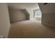 Open attic space with dormer windows and ample room for storage or customization at 194 Landon Ridge, Sanford, NC 27330