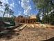 View of the framed home under construction showing wall and roof structure under construction with lumber at 194 Landon Ridge, Sanford, NC 27330