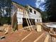 Exterior view of the new home construction; ladder against structure with lumber on the ground at 194 Landon Ridge, Sanford, NC 27330