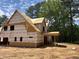 A partially constructed home shows a covered porch area with exposed framing and the home surrounded by trees at 194 Landon Ridge, Sanford, NC 27330