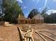 A home under construction has partially completed framing and is surrounded by piles of lumber and a large lot at 194 Landon Ridge, Sanford, NC 27330
