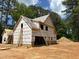 A partially constructed home shows exposed framing with a ladder leaning against it and a pile of dirt in the background at 194 Landon Ridge, Sanford, NC 27330