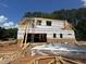 New construction home showing framed walls, roof trusses, and covered for weatherproofing at 194 Landon Ridge, Sanford, NC 27330