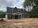 New construction home featuring green siding, black roof and white framed windows at 194 Landon Ridge, Sanford, NC 27330