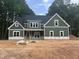 New two-story home with green siding, white trim, and black roof, surrounded by trees at 194 Landon Ridge, Sanford, NC 27330